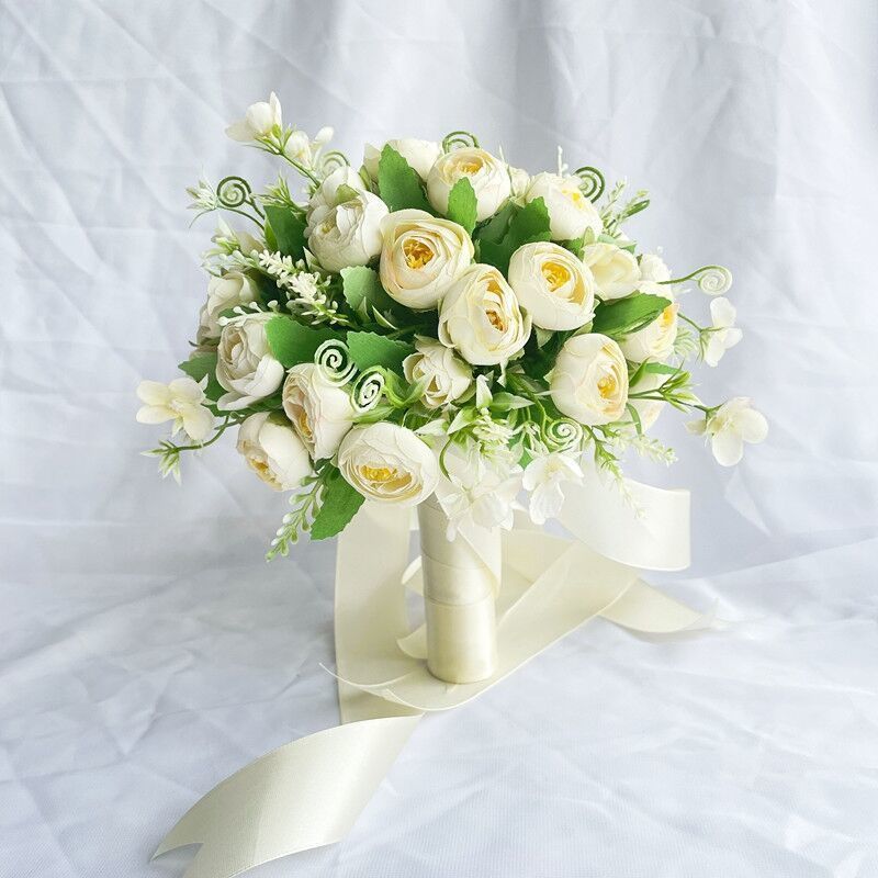 手に花を持つ新婦の韓国式結婚式の領収書のシミュレーションの花束の森系のウェディングドレスの撮影の道具の手に花をささげます。|undefined