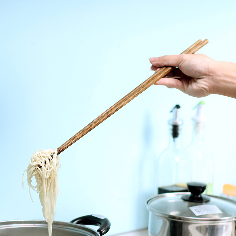 Extend the chopsticks to prevent hot and furnish noodles. Eat hot…
