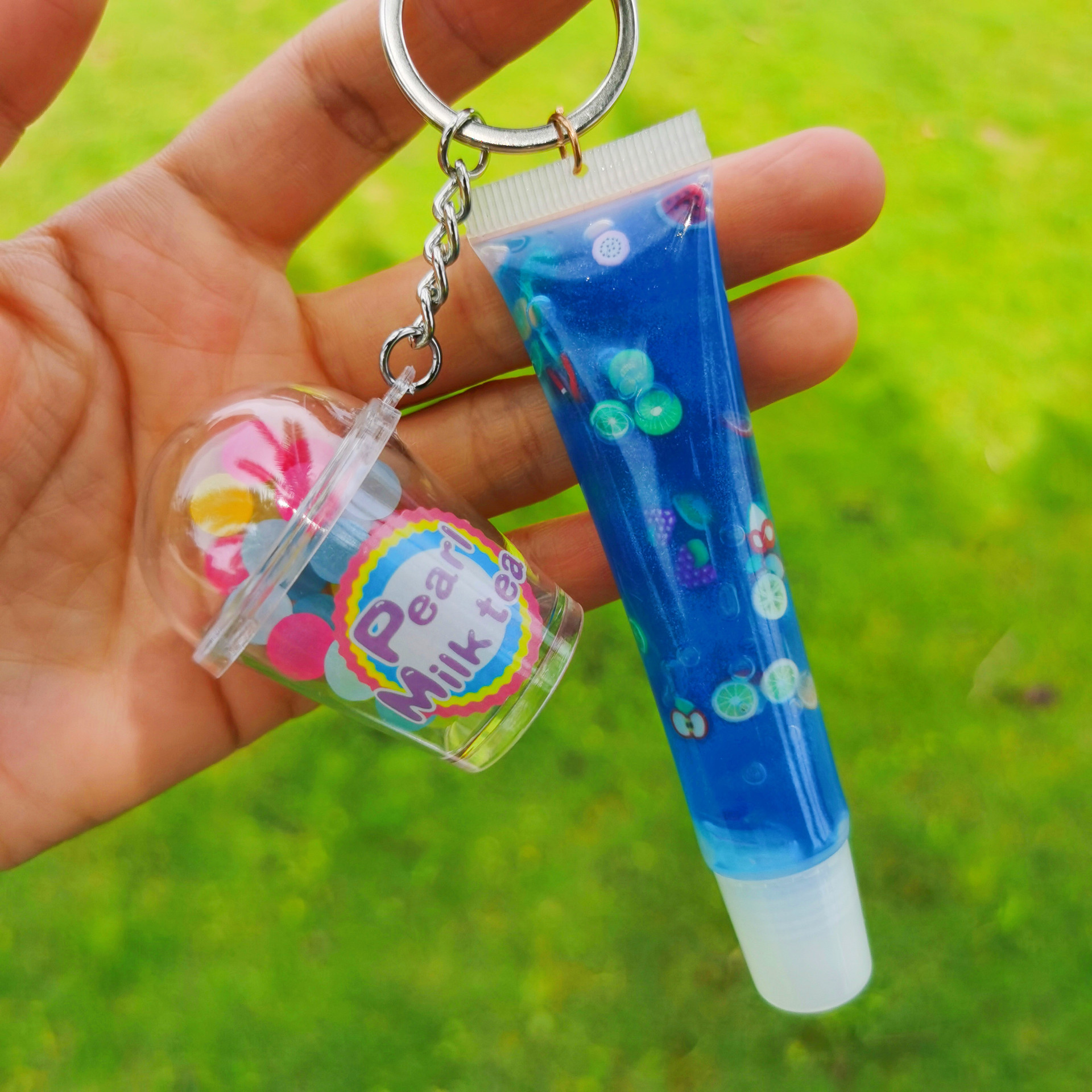 Shangxin niños cosméticos mecedora música llavero colgante tropical fruta niños piel bola colgante labio esmalte no lo