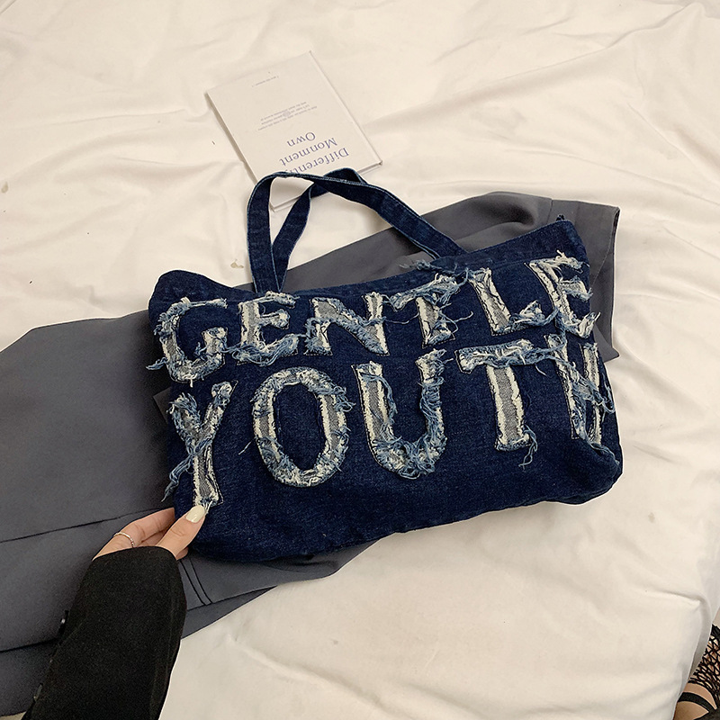 Nueva mochila de hombro de mezclilla retro, bolso de lona con letras de ocio, bolso de viaje artístico para estudiantes