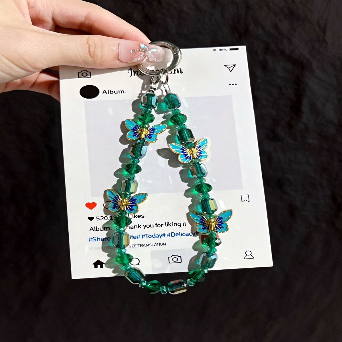 Cadena de teléfono móvil al por mayor cadena de cuentas de cristal flor de mariposa sentido de alta gama cadena corta hecha a mano para mujer bolsa de viento NIS todo fósforo