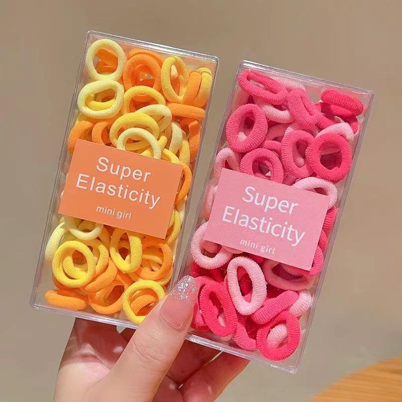 Asequible caja de almacenamiento de Corea del Sur de los niños pequeño tamaño cabeza cuerda bebé toalla anillo no duele pelo cabeza cuerda macaron pelo anillo