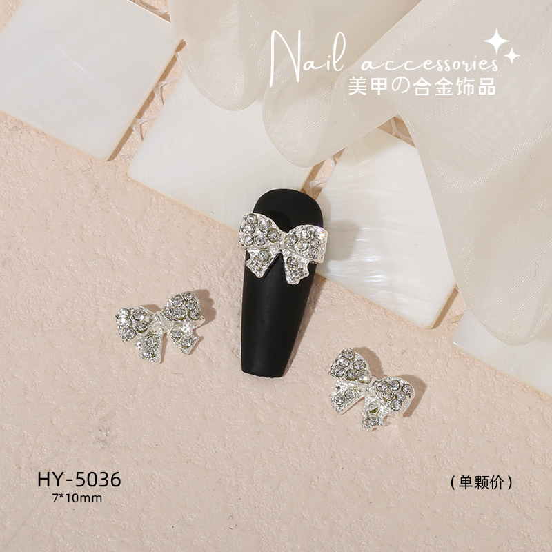 Nuevo arco de uñas amor aleación decoración de uñas flor de la luna mariposa clavo taladro fábrica joyería al por mayor