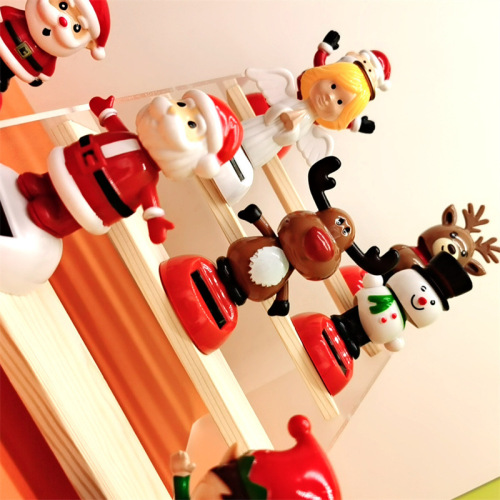 Cross-border Christmas solar-powered automatic swinging doll car shaking head decoration creative car car ornaments