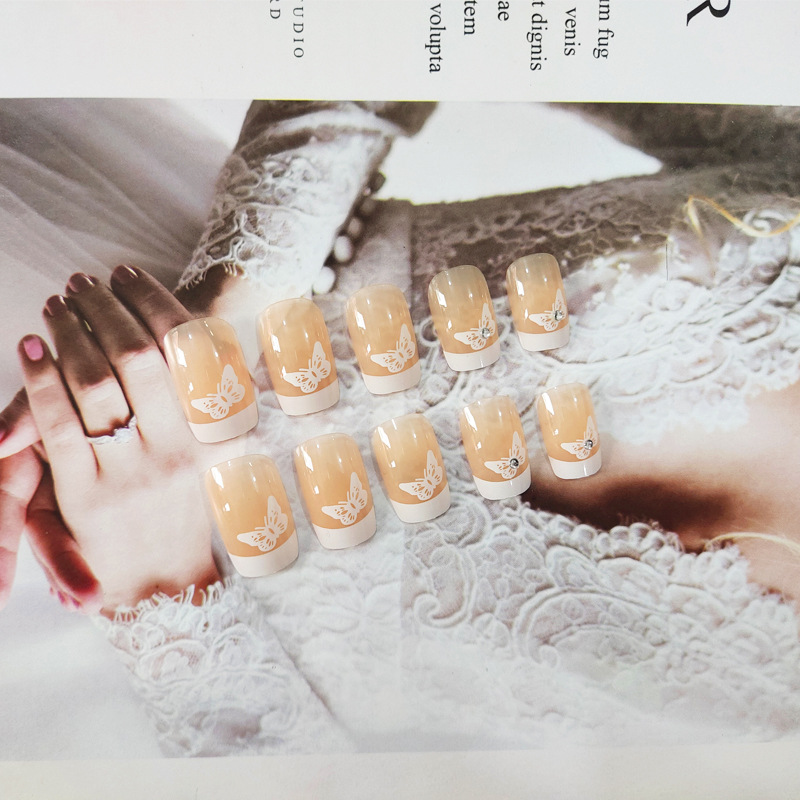 Polvo desnudo punto de perforación mariposa para usar uñas de borde blanco largo estilo francés fresco y elegante 24 piezas de parche de uñas terminadas