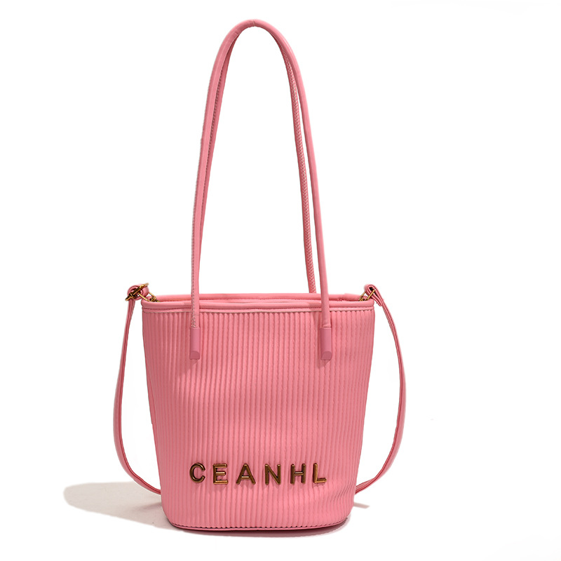 2025 otoño y invierno nuevo pequeño bolso a rayas de viento fragante bolso de cubo simple bolso de hombro de tendencia de mujeres bolso de mochila popular