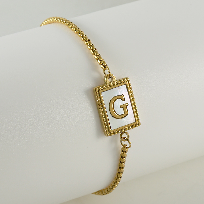 Nuevo europeo y americano transfronterizo de acero inoxidable 26 letras inglesas Shell pulsera personalidad todo partido titanio acero 18K cremallera