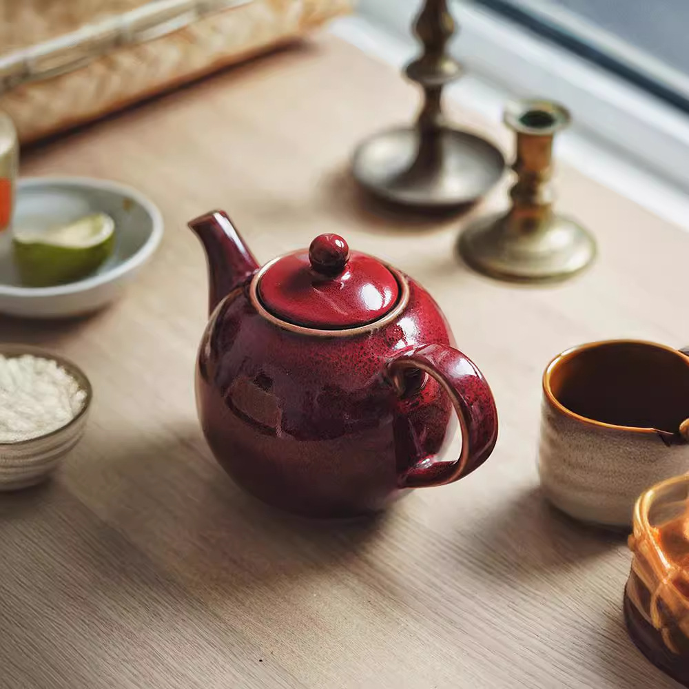 Tetera de cerámica europea creativa tetera de té de la tarde tetera de té de kung fu doméstica tetera de té de alta temperatura tetera de agua redonda de color