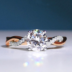 Stunningly elegant rose gold and white gold two-tone rhinestone engagement ring with twisted shank and four-claw setting.