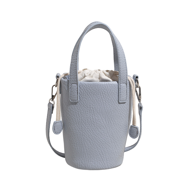 Bolso de cubo de cuero de cera de aceite retro con patrón de lichi transfronterizo para mujer 2025 nuevo bolso de mensajero de un solo hombro de diseño de nicho de alta gama