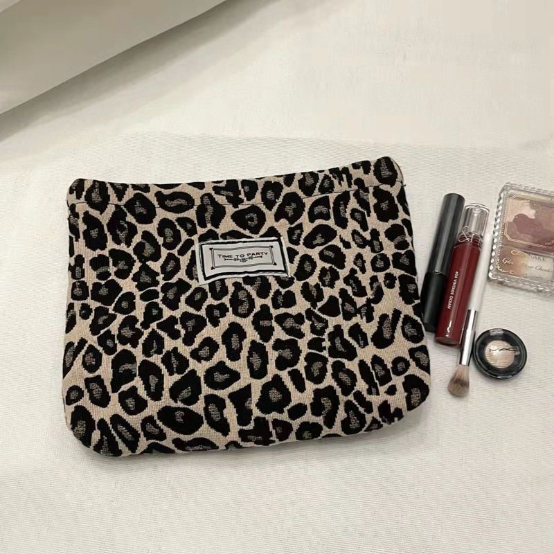 Bolsa de cosméticos original nicho diseño blanco y negro elegante a rayas retro artístico elegante portátil de mano bolsa de cosméticos al por mayor