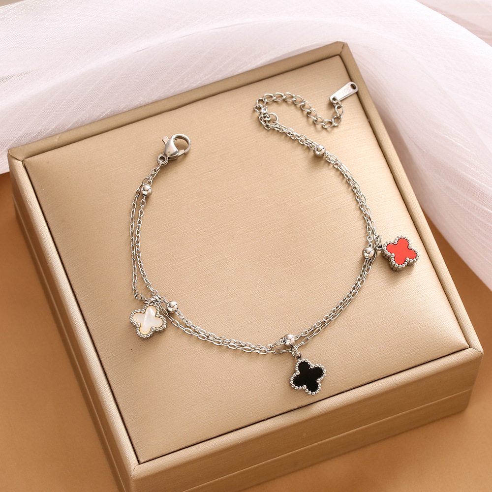 Pulsera de trébol de acero titanium vendedora caliente transfronteriza europea y americana con incrustaciones de concha pulsera colgante pulsera de diseño avanzado sin desvanecimiento al por mayor
