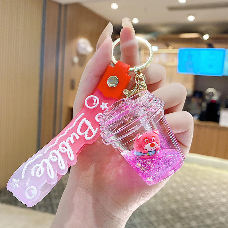 Botella de arena flotante de aceite flash fresas oso muñeca colgante llavero mochila para hombres y mujeres colgantes de automóviles pequeños regalos al por mayor