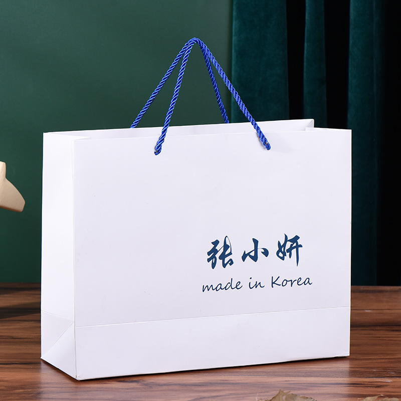 时尚女装手提纸袋定 做服装店包装购物礼品袋 广告白卡纸袋印logo