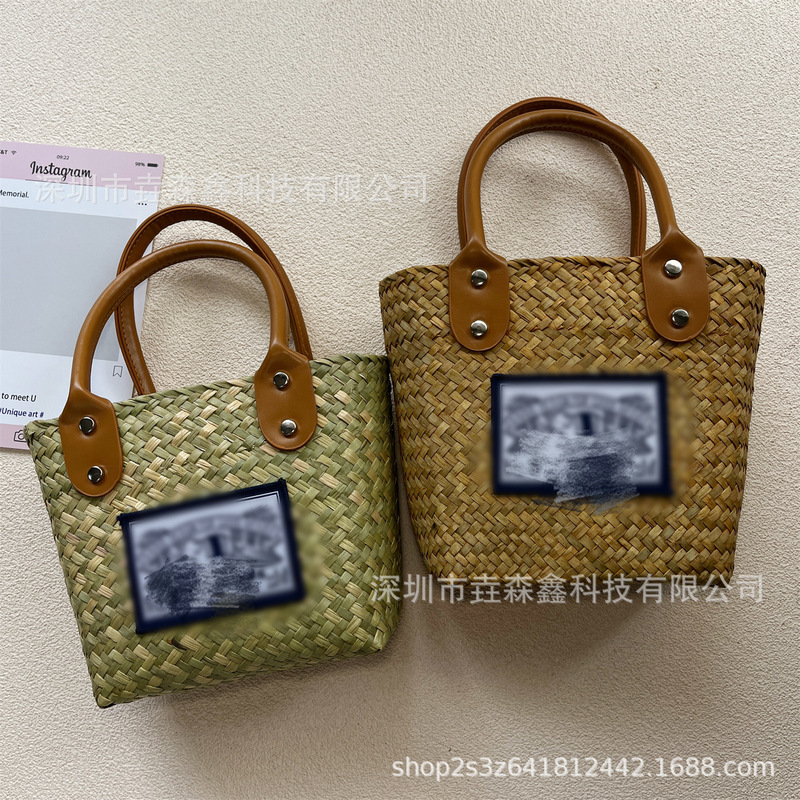 Factory wholesale straw bag hand woven niche design hand carrying women's bag portable bag beach bag