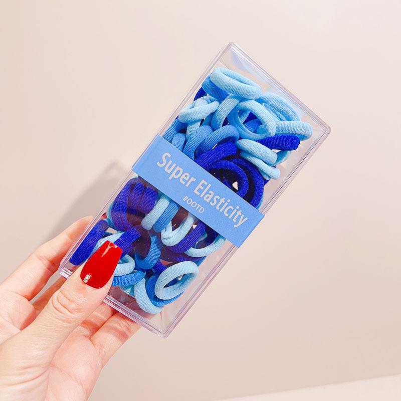 Asequible caja de almacenamiento de Corea del Sur de los niños pequeño tamaño cabeza cuerda bebé toalla anillo no duele pelo cabeza cuerda macaron pelo anillo