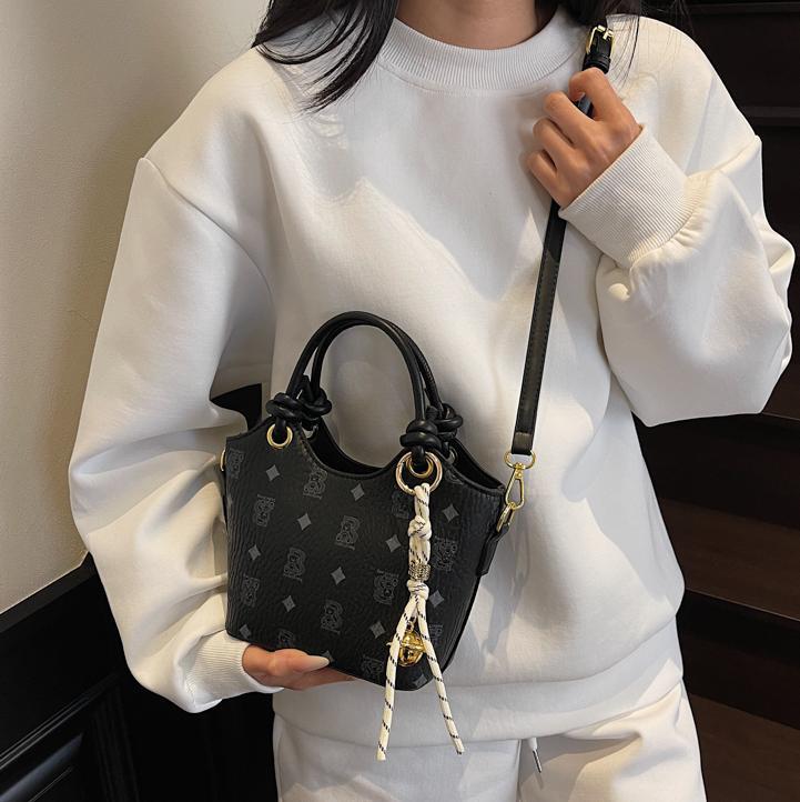 Tendencia impresa bolso de cubo de mano mujer 2025 nueva moda textura versátil bolso de hombro super caliente bolso de mochila