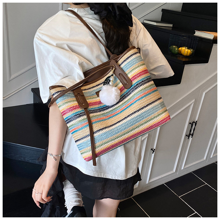 This is a new 2025 summer beach-style women's bag with a simple and versatile hand-held design. It's a single-shoulder vacation woven bag undefined
