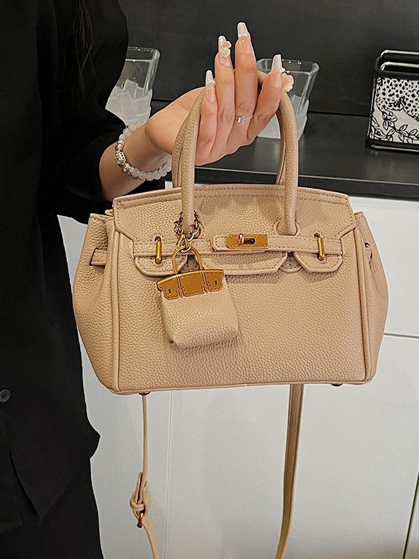 Bolso Kelly de moda coreana para mujer, nuevo modelo transfronterizo de gran venta con textura de alta calidad y diseño de lichi, bolso de hombro y bandolera.