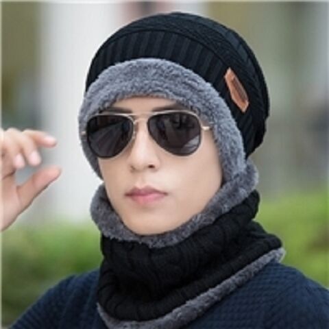 New winter knitted woolen hat with fur lining and thickening for warmth. New striped knitted hat for cold protection when riding a bike. 