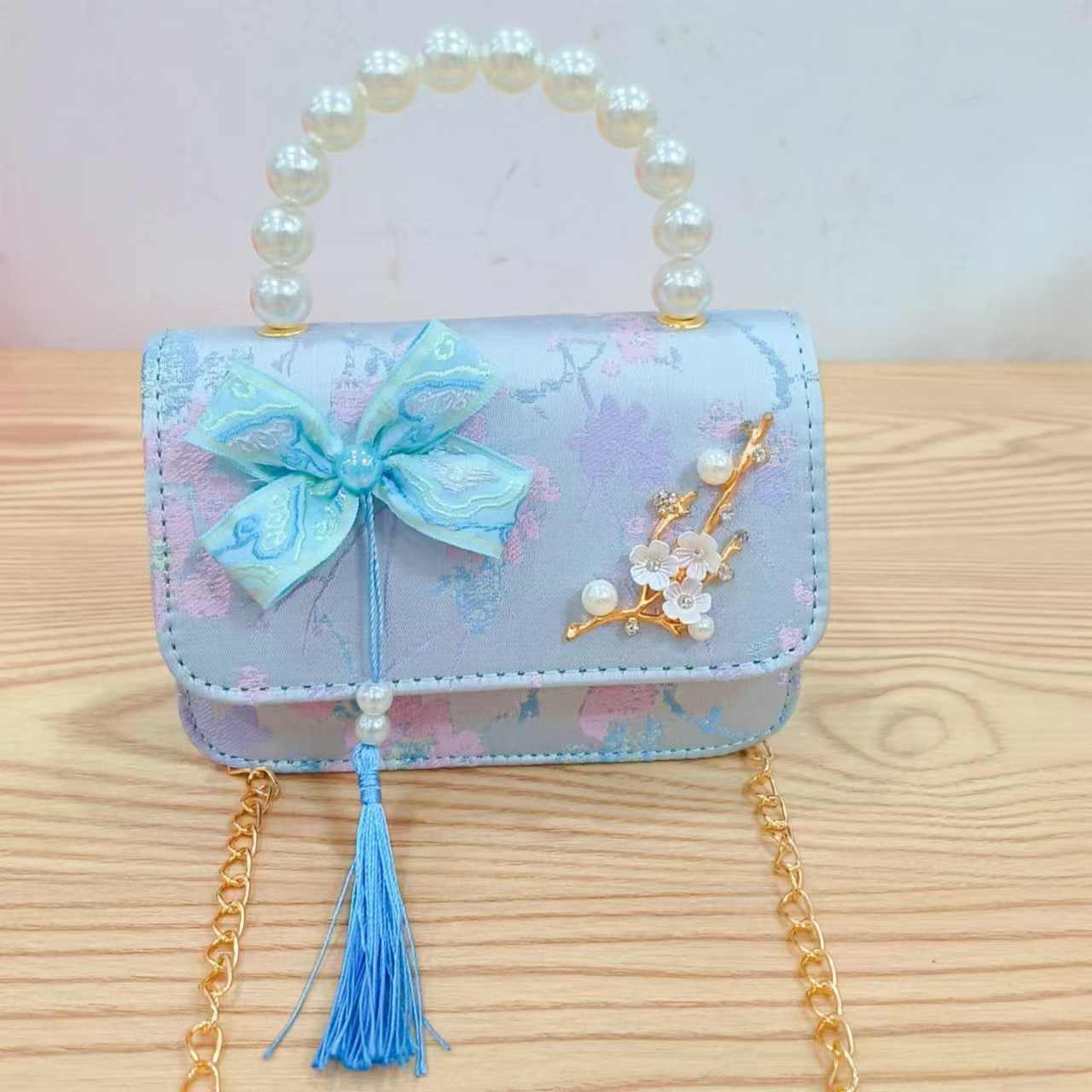 Bolsas de niños arco de estilo chino borda de niña pequeña princesa perla bolsa de cambio de mano al por mayor