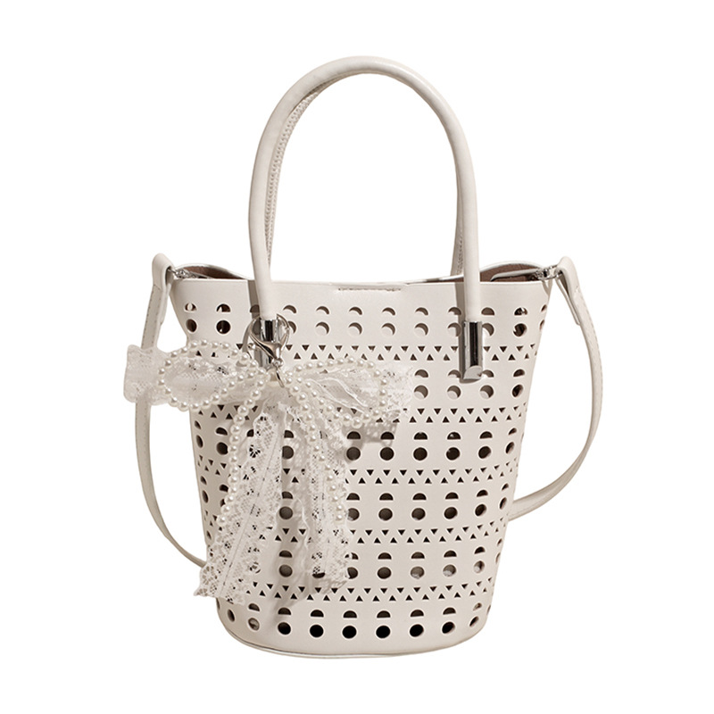 Bolso de cubo de diseño de nicho 2025 nuevo bolso de hombro con agujero hueco bolso de mensajero con lazo de estilo occidental mujer