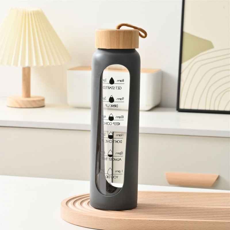 Taza de vidrio con tapa de bambú de gran capacidad transfronteriza, cuerda de elevación, cubierta de silicona portátil, taza de agua graduada, botella de agua deportiva de vidrio de alto valor