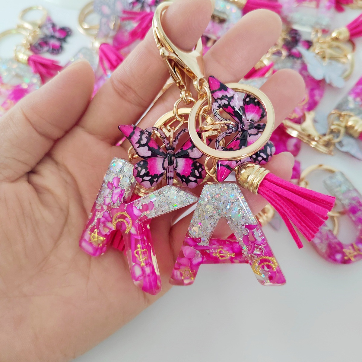 Inventario transfronterizo nueva resina bicolor mariposa borda llavero colgante estrella luna accesorios de joyas