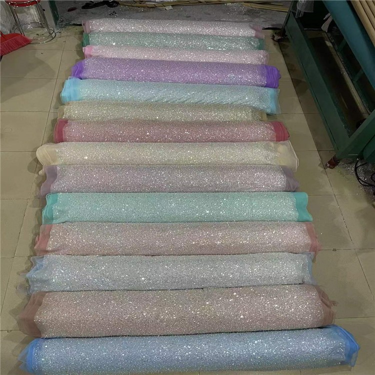 Fabricantes de comercio exterior transfronterizo punto bordado de polvo de polvo brillante tela vestido de boda ropa de moda tela