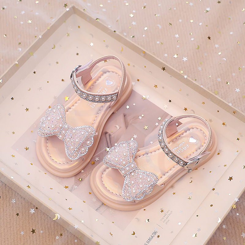 Niños verano 2026 nuevas sandalias de niñas arco brillante con base suave princesa sandalias de viento para niñas sandalias