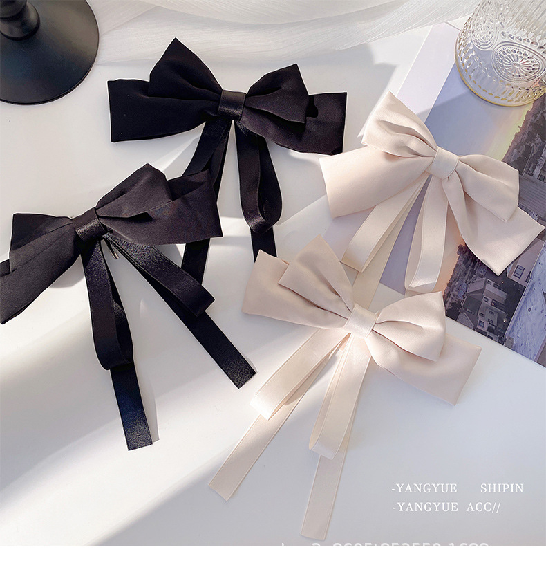 Satin-style elegant hair accessories: fabric top clip, bow tie, brooch, and ribbon-inspired design in sophisticated solid colors