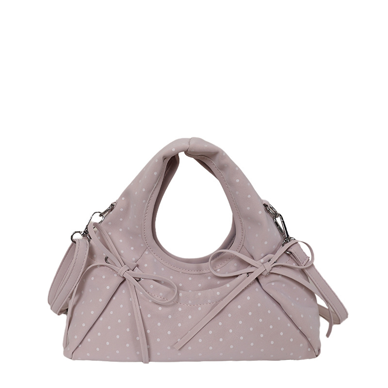 Bolsa de mano de arco exquisita coreana para mujeres verano 2026 simple diaria versátil onda punto sensación de hombro mochila
