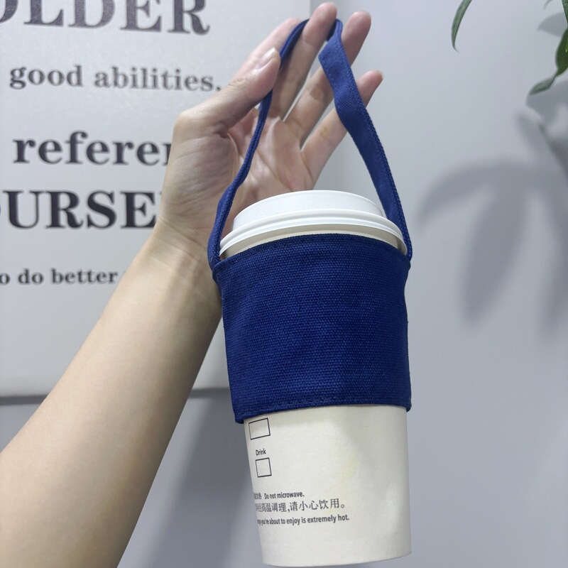 素顔のカップカバーの空白ミルクティーの手は飲み物のカップの手提げ袋の真珠のミルクティーの袋の環境保護のキャンバスを振ります。|undefined