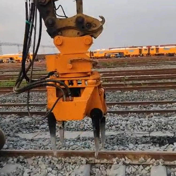 Машина для уплотнения железнодорожных путей, экскаватор, оснащенный гидравлической машиной для уплотнения балласта.