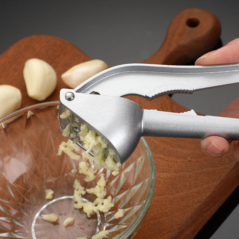 Triturador de nueces y frutos secos para el hogar, prensa manual de ajo, triturador de pasta de ajo, abridor de cáscaras, herramienta de cocina multifuncional. image 1