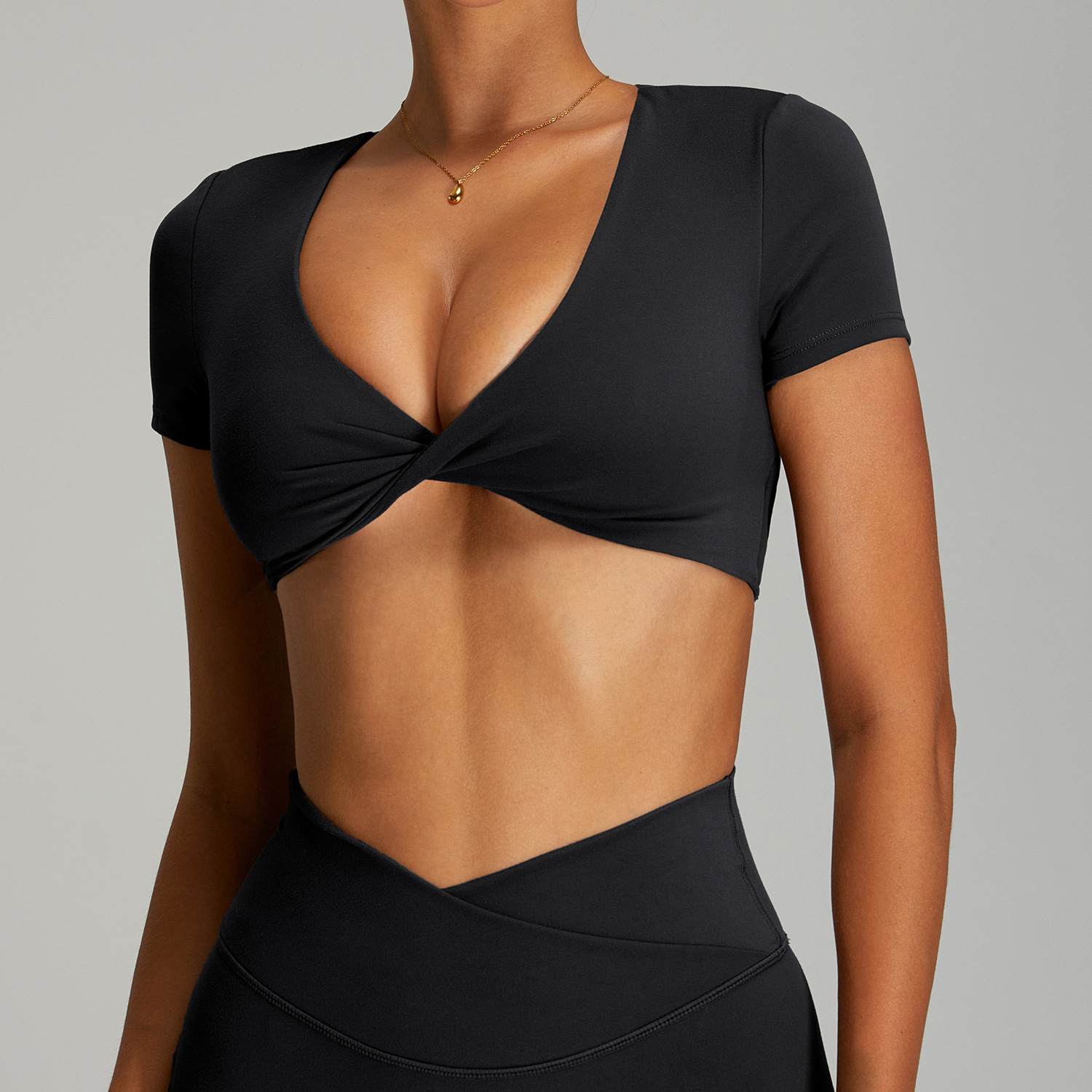 Camiseta deportiva sin espalda sexy femenina de manga corta de yoga de secado rápido europeo y americano con almohadilla para el pecho Top deportivo corto para correr