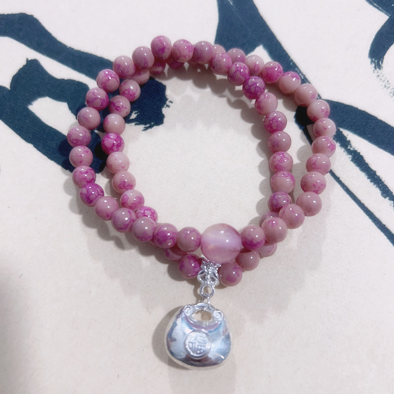 Bracciale con perline rosa e ciondolo portafortuna donna_voghion.com