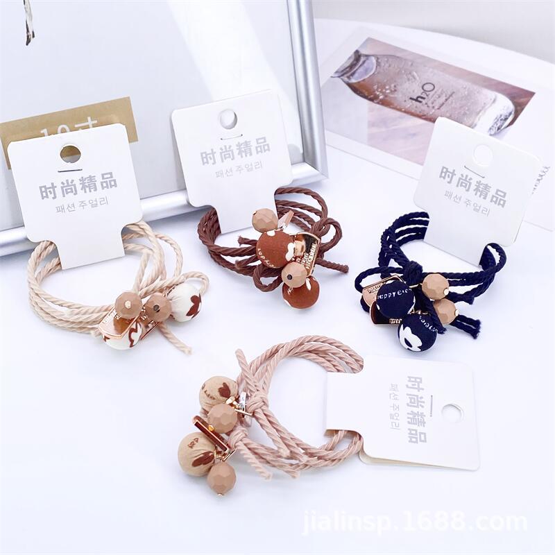 Otoño e invierno té de leche color paño bola cuerda del pelo 2 tarjetas leopardo cabeza cuerda simple hilo colgando bola banda de goma 2 yuanes tienda de suministro