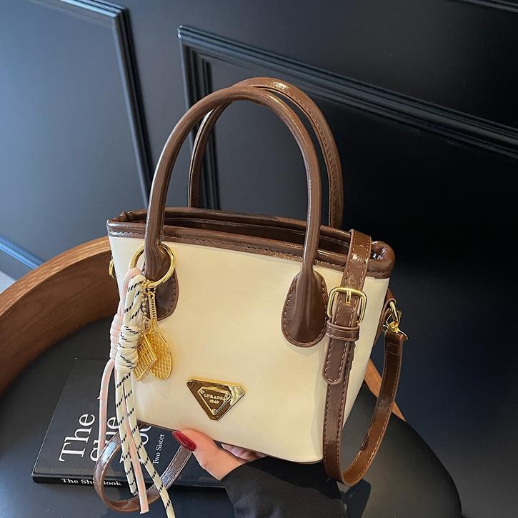 Bolso de mano de moda versátil para mujeres 2025 nuevo color de contraste de moda de un solo hombro bolso de cubo de alta sensación de mochila casual