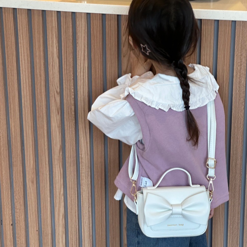 2025 nuevo bolso para niños mini accesorios para niños bolsos de mano simple color sólido arco extranjero bolso de hombro para niñas