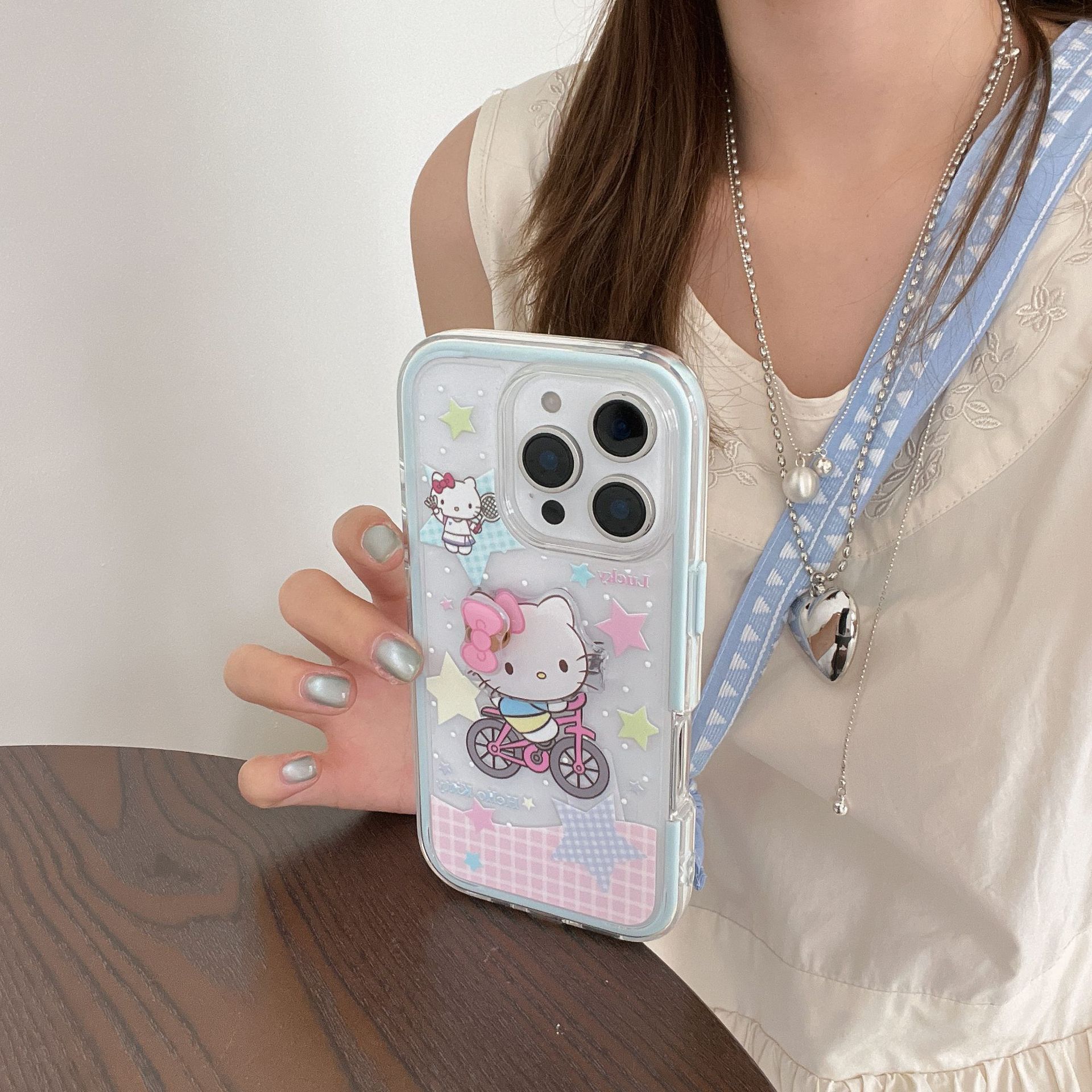 Lindo paseo en bicicleta de dibujos animados KT gato para Apple 15/16 funda para teléfono móvil 14ProMax dos en uno 16Pro femenino 16PM