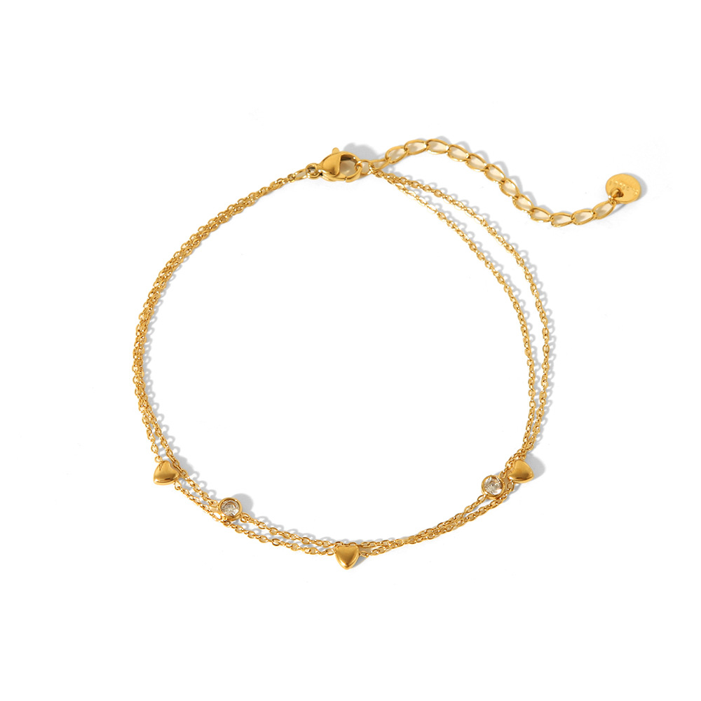 Estilo francés acero de titanio horno de 18K galvanoplastia de oro real doble amor circón tobillera verano femenino todo fósforo joyería de playa