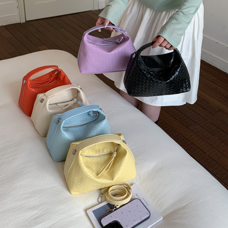 Nicho trenzado bolso de cubo para mujeres 2026 verano nuevo bolso de hombro portátil bolso de gran capacidad diaria