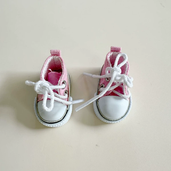 A pair of pink canvas shoes