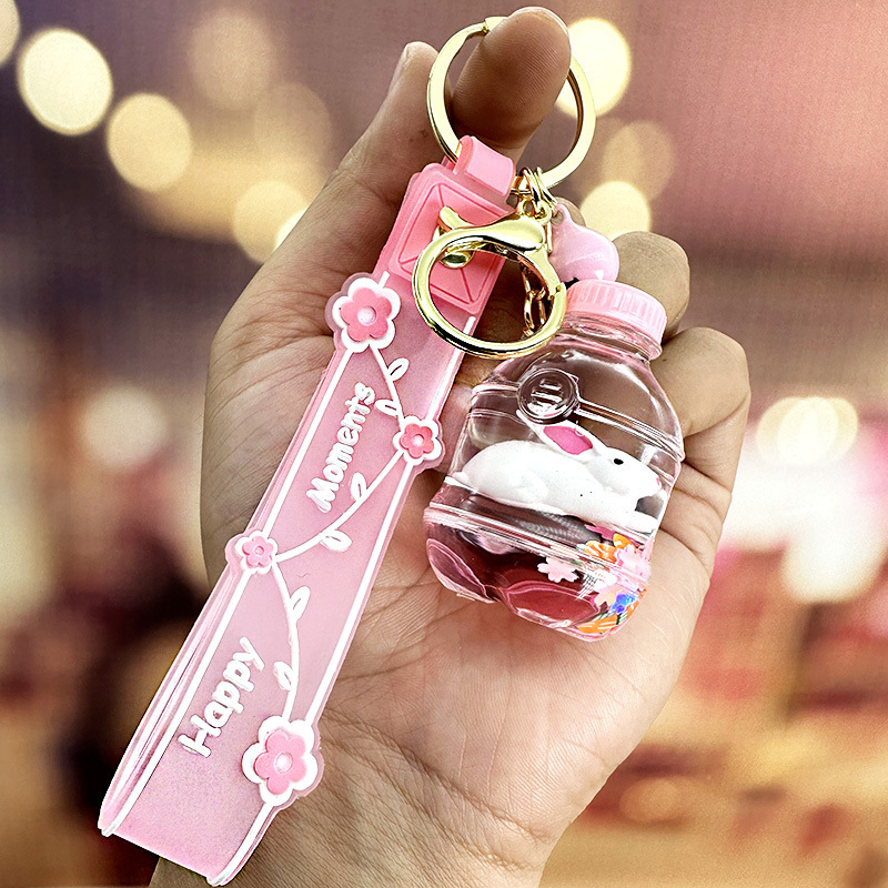 Colgante de llavero de conejo de botella de arena rosa, muñeca flotante creativa, decoración de mochila para niña, regalo exquisito para pareja