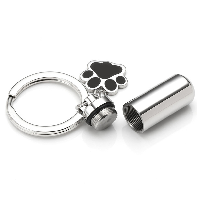 AliExpress venta caliente de acero de titanio memorial parientes mascota cinerario ataúd colgante puede abrir cilíndrica sello de pata botella de perfume collar