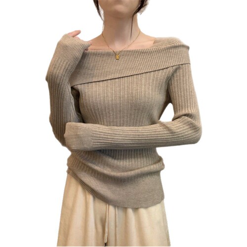 Off-shoulder knitted base shirt for women, autumn wear—irregular layered sweater with French-inspired high waist and bare-shoulder design, featuring long sleeves that highlight the collarbone.