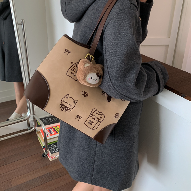 时尚百搭简约2025新款托特包包女通勤大容量小熊手提单肩女式包