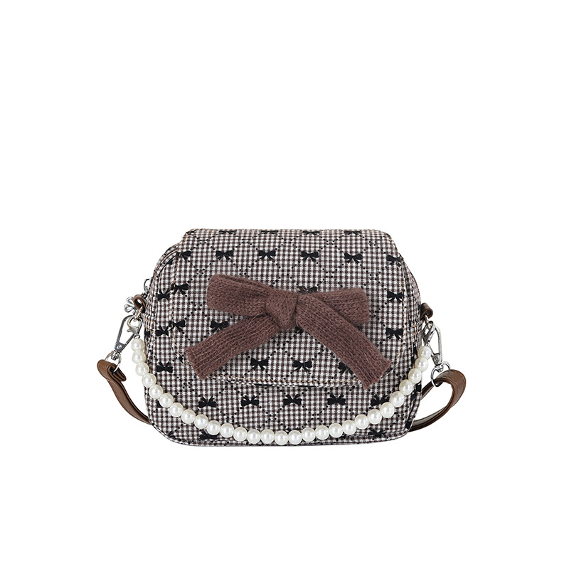 Arco encantador extranjero, bolso de hombro de niña, bolso de perla de diamante de moda, nuevo bolso de cambio para niños.