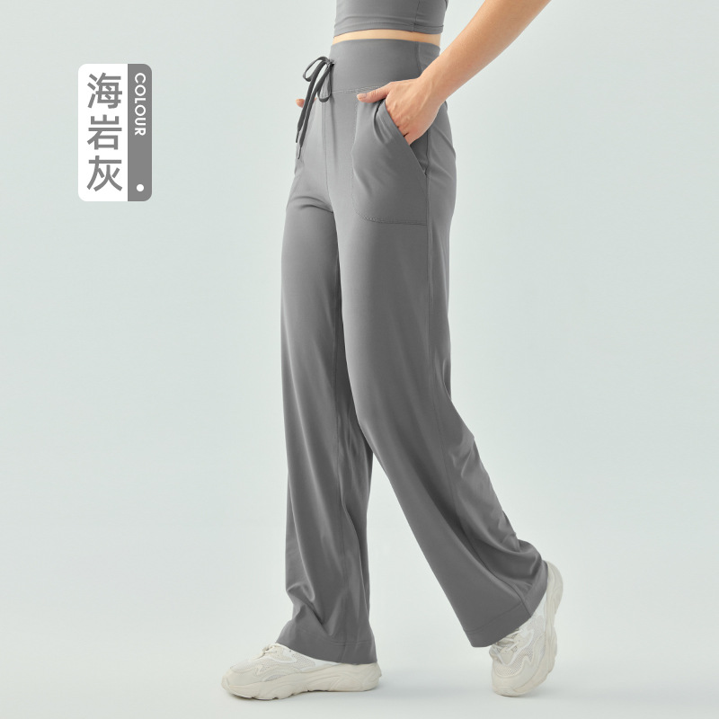 裸感の高い腰のひもの運動のズボンの女性のゆったりしている広脚の純色のフィットネスのズボンのランニングはスリムに見えます。